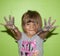 Creative Girl with Paint on her Hands makes a mess with painted hands in front of a Green Screen