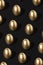 Creative gold eggs pattern over dark black background. Minimal black luxury Easter concept