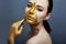 Creative grim makeup face of girl Golden color zipper clothing on skin. Fashion beauty creative cosmetics and skin care halloween