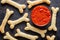 Creative Halloween dough bones cookies snack with fake blood tomato sauce and mozzarella