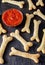 Creative Halloween dough bones cookies vegetarian snack with fake blood tomato sauce