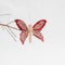 Creative handmade butterfly on a branch on a white background