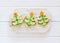 A creative idea for decorating New Year`s snacks. Sandwiches in the form of a Christmas tree with a cucumber and a carrot star on