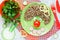 Creative idea for kids dinner or breakfast - buckwheat with sausage and vegetables in the shape of clown face. Fun food art for c