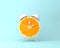 Creative idea layout fresh orange slice alarm clock on pastel bl