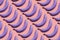 Creative idea in a surrealistic style purple bananas on a pink background