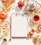 Creative inspiration and ideas autumn flat lay with blank clipboard on white desk with  pumpkin, apples, mini donuts, pastry ,