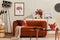 Creative interior composition of living room with mock up poster frame, designed couch, coffee table, plants and personal.