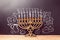 Creative Jewish holiday Hanukkah background with menorah over chalkboard with hand drawing