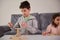 Creative kids, boy and girl focused on building from wooden blocks, playing developmental board games, building complex tall