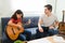 Creative latin kid playing music on her guitar