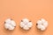Creative layout of cotton flowers in a row on a pastel peach color background. The concept of ecology and nature. Top view, flat