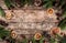 Creative layout frame made of Christmas fir branches, spruce, slices of orange, pine cones, snowflakes on wooden background