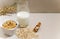 Creative layout of granola, muesli, milk in a glass on a beige background. The concept of a correct healthy diet. Copy text