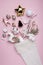 Creative layout made with Christmas socks with gifts and decorative ornaments on pastel pink background