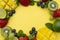 Creative layout made of summer fruits, frame. Tropical flat lay. Grapes, mango, strawberry, blueberry, kiwi, mint, lime, citrus