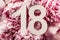 Creative layout. Peony flowers, digit eighteen. Birthday greeting card with inscription 18. Anniversary concept. Top view. Copy