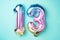 Creative layout. Rainbow foil balloon number, digit thirteen. Birthday greeting card with inscription 13. Anniversary