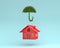 Creative layout of Red house with plant umbrella floating on blu