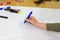 Creative Learning: Young Student Expressing Ideas with Colorful Pens in Classroom