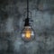 Creative lighting hanging lightbulb on industrial cement background