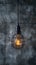 Creative lighting hanging lightbulb on industrial cement background