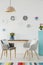 Creative living room interior with plates on the wall, table, gr