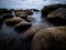 Creative longtime photo over a rock beach with fantastic Clouds on the sky