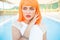 Creative look of woman in orange wig by the pool