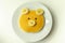 Creative meal for a child, pancake with banana and chocolate  in a face little bear  shape