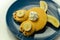 Creative meal for a child, pancake with banana, chocolate and whipped cream in a rabbit shape