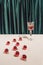 Creative minimal Christmas or New Year party composition with vintage cocktail glass ad red baubles. Retro aesthetic style