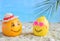 Creative minimal summer idea. Citrus hipster. Orange in bamboo hat and lemon in sunglasses on sand. Tropical beach concept. Creati