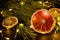 Creative moody holiday Christmas New Year food fruits with dried grapefruit, kiwi, orange and lemon with branch of fir tree