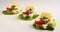 Creative party canapes on lettuce with tomato, pesto and cheese