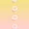 Creative pattern of flying banana slices on pastel pink and yellow gradient background.