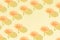 Creative pattern made with flowers on a yellow background. Copy space. Minimal Women`s day and spring concept