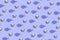 Creative pattern made of martini glass with silver decorative baubles and bows on pastel lilac background. Party and festive