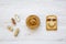 Creative pattern made of toast, peanut butter and peanuts in shells, top view.