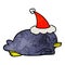 A creative penguin lying on belly wearing santa hat