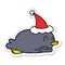 A creative penguin lying on belly wearing santa hat