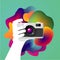 Creative photo art. Hand is holding a camera. Vector illustration.
