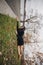 Creative photo of a brunette girl in autumn Park. Woman hanging from edge, lying on the green grass. Look at the world from side