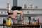 Creative photo of muscular man in the kitchen balancing bottle with souse