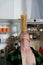 Creative photo of muscular man in the kitchen balancing pasta on the forehead
