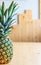 Creative pineapple on the light wooden background. Healthy eating fashion lifestyle concept. Copy space