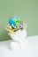 Creative plaster vase head-shape with flowers and world globe. Save the planet, Earth day concept