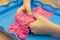 Creative play for children. Education and parenting. Children playing with pink kinetik sand