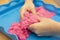 Creative play for children. Education and parenting. Children playing with pink kinetik sand