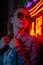Creative portrait of a girl in neon lighting with glasses